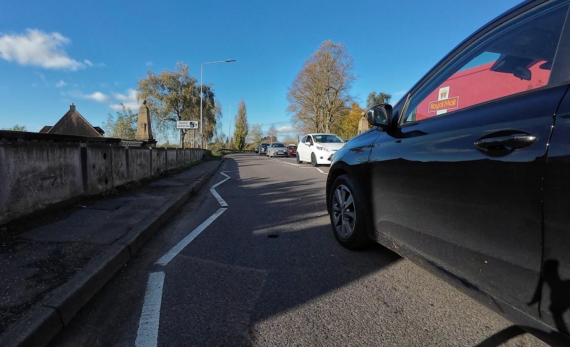 A car overtaking a cyclists without leaving enough space